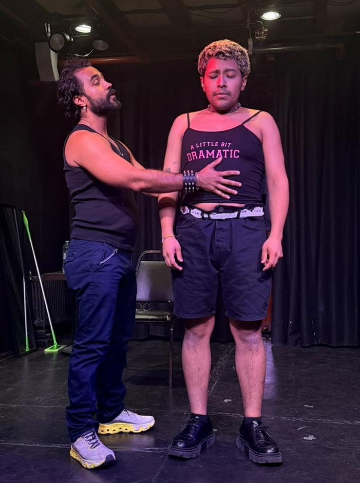 Actor delivering a dramatic line to another actor on stage
