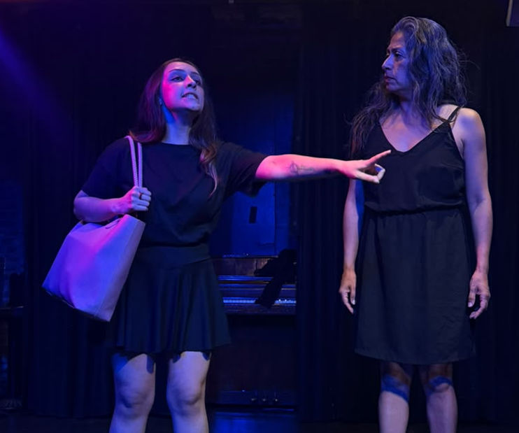 Actress pointing accusingly at another actress in a tense scene
