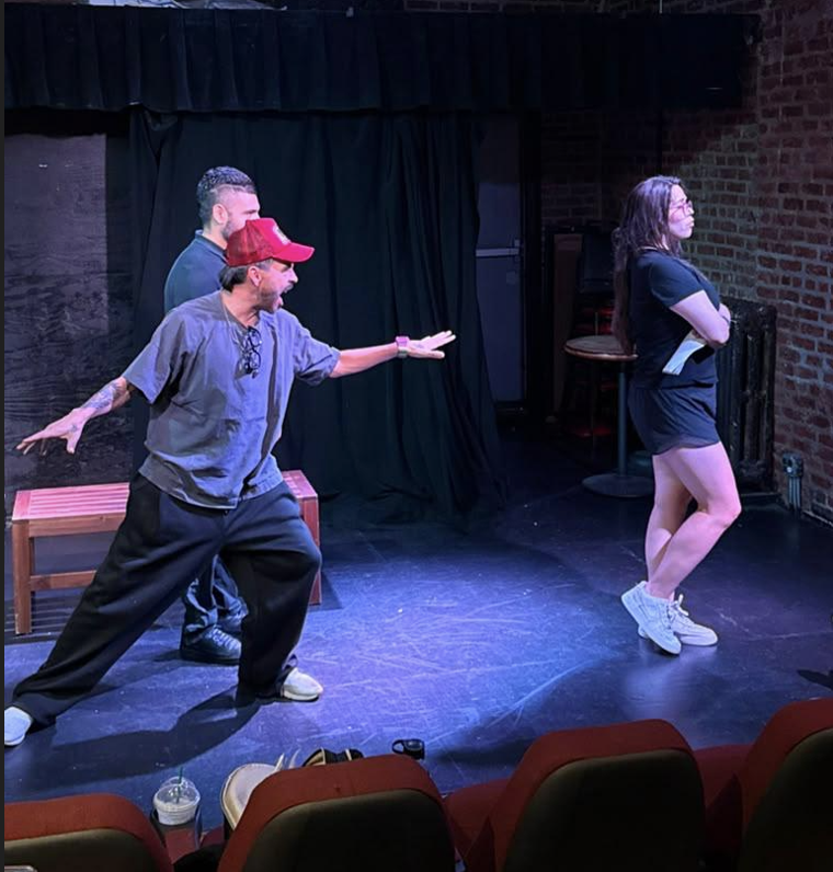 Two actors and an actress in a confrontation scene on stage