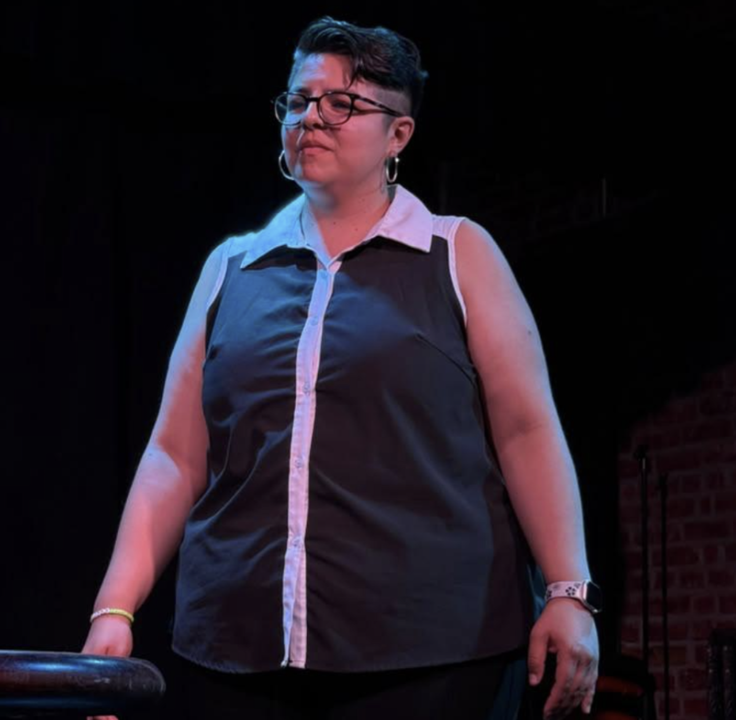 Actress standing on stage in a quiet moment